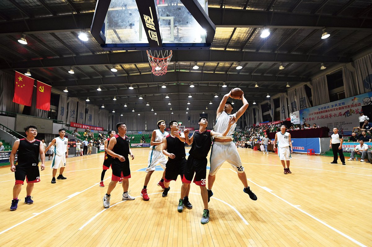 Hongxi village playing against Hongnan village in an inter-village basketball championship in 2018