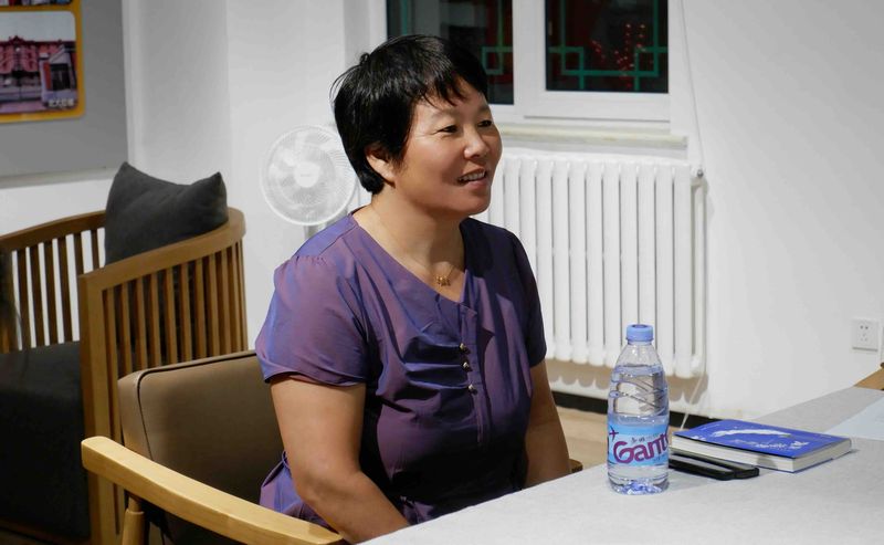 Han Shimei sits at a desk, female poet in rural china