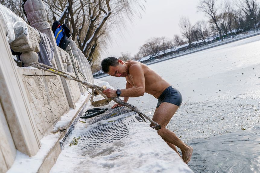 A man in underwear scaling a wall, First snow in Beijing in 2023