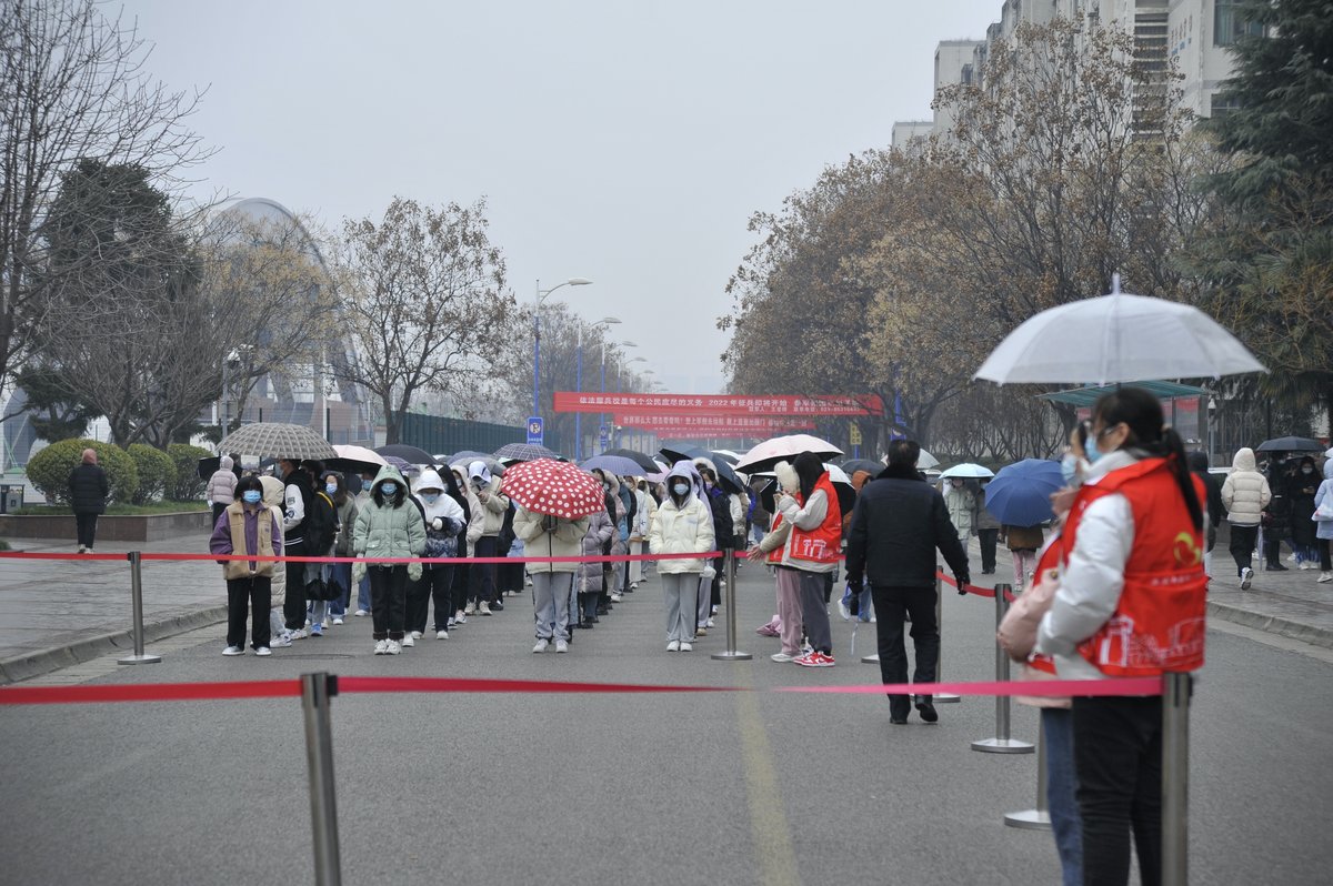 Students about to take the national postgraduate entrance exams queue up in designated areas on campus