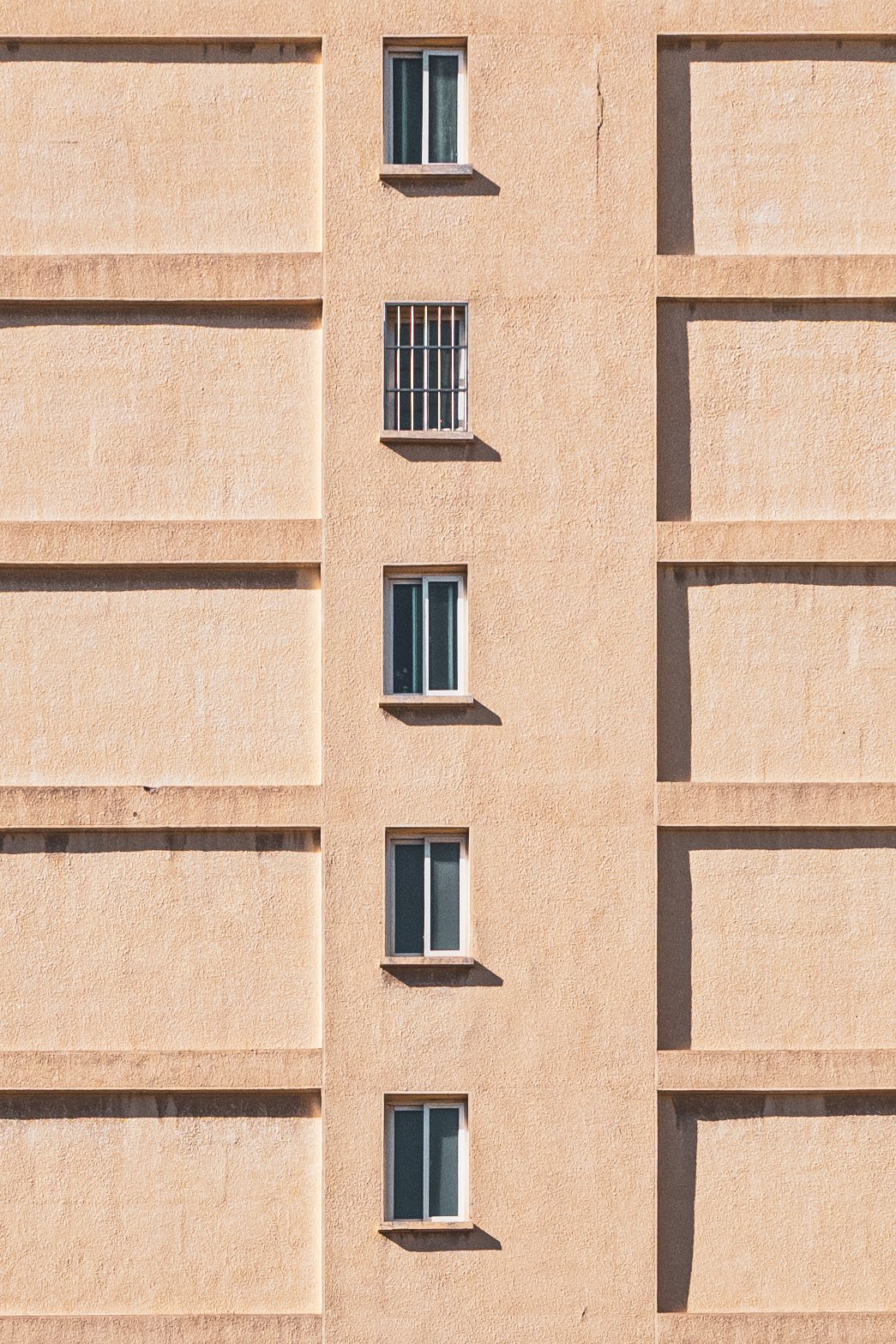 Small bathroom windows on the side of buildings are a common design feature.