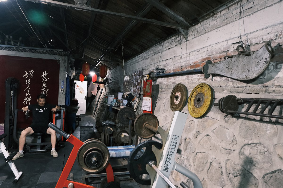 Li Shulin, 65, works out his arms at Erqi Fitness Gym. He comes to exercise four times a week.