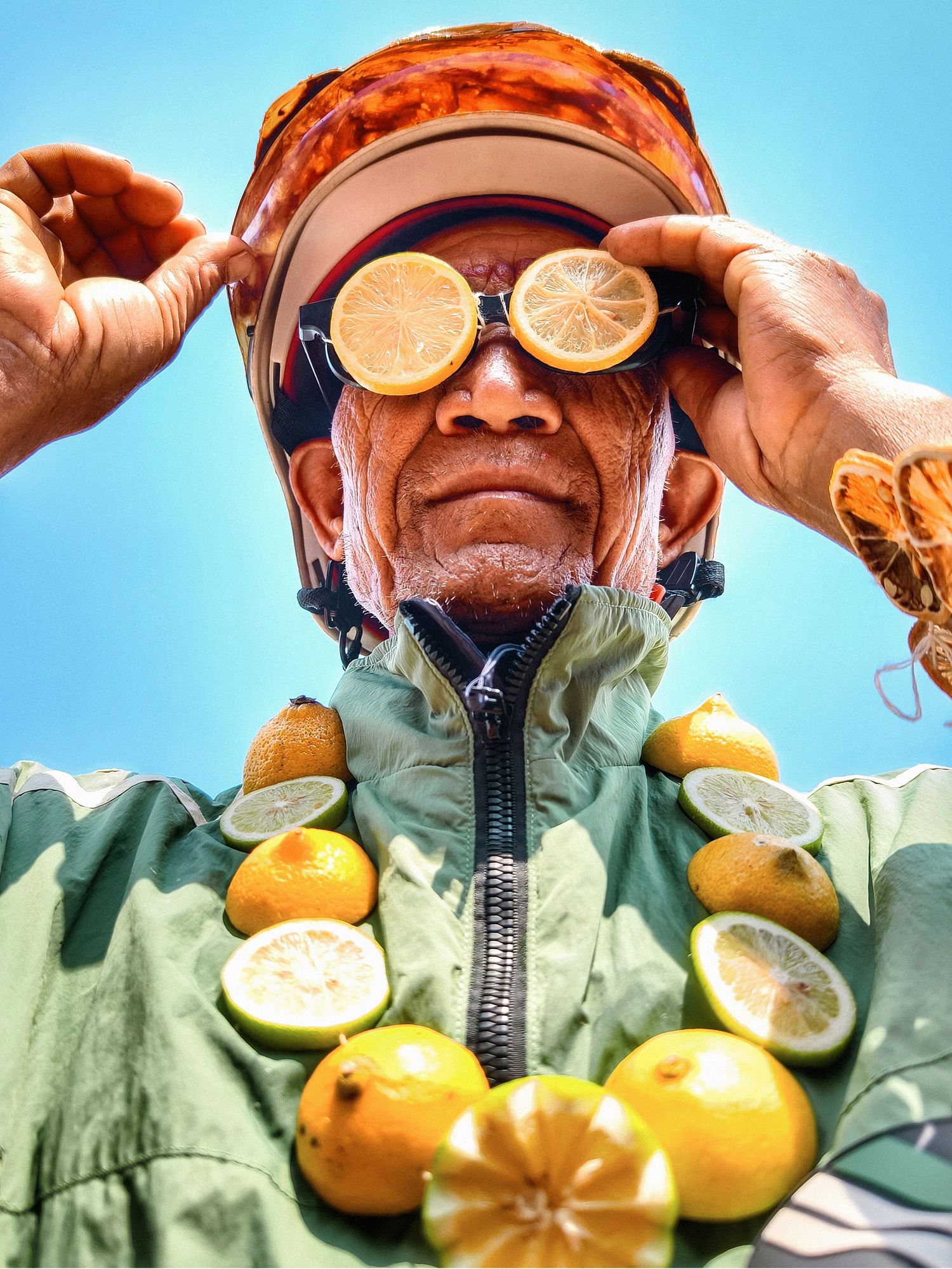 Villager wearing a necklace made of lemons and other tropical fruit