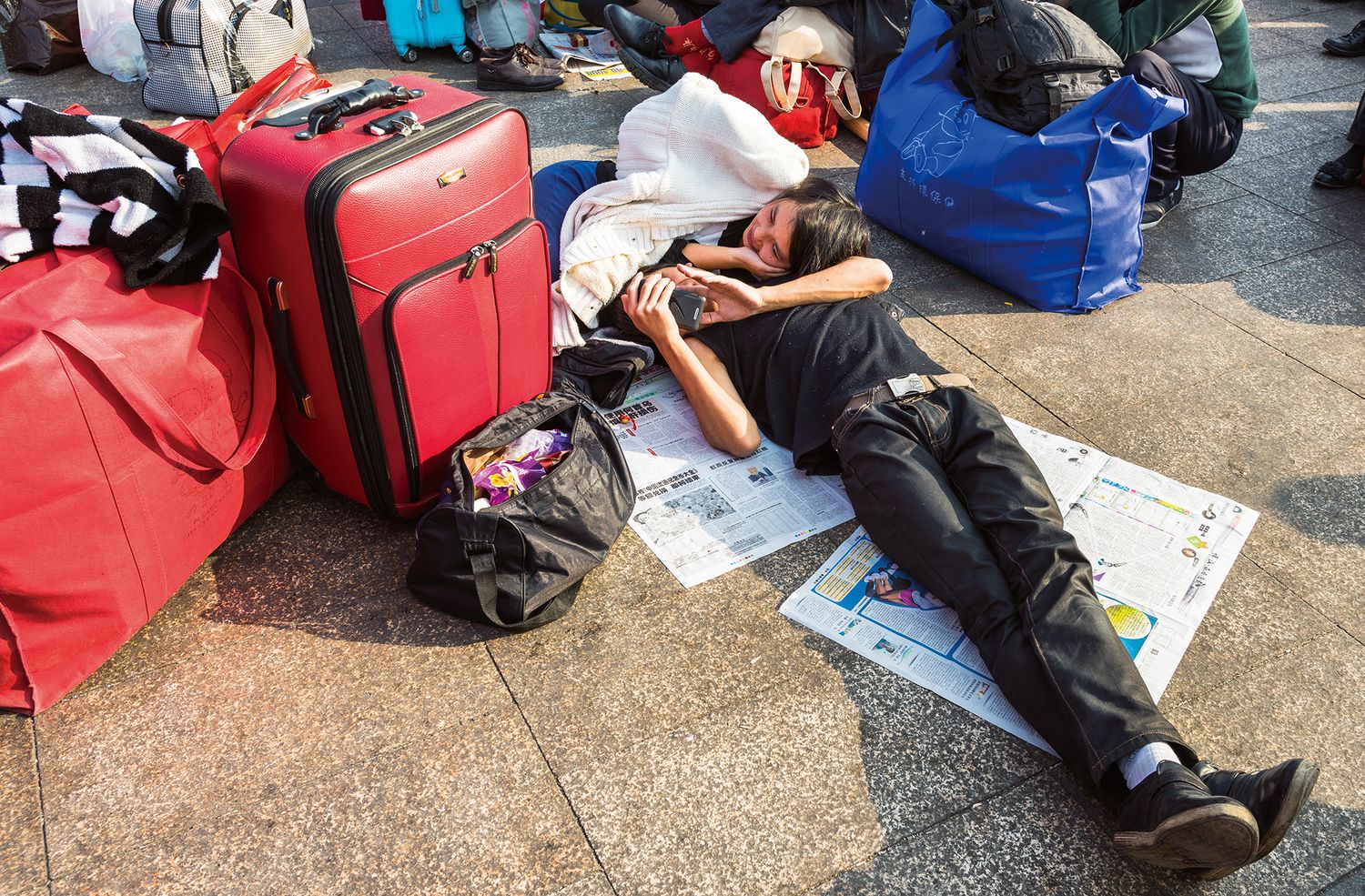 “A Short Snooze While Traveling”” The “Spring Migration,” China’s Lunar New Year Travel Season, is usually called the biggest human migration in the world (Guangzhou, Guangdong Province, January 2014)