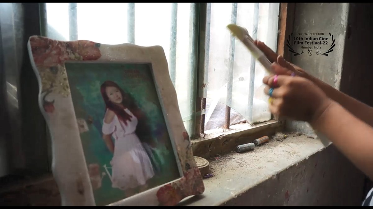 A child wiping their mother’s photo