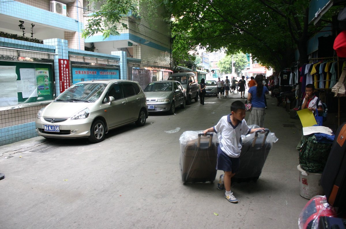 Children help their families move in Yangji village