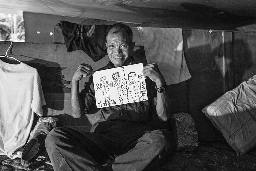 Homeless man under a bridge in Hong Kong, photography Hong Kong’s housing crisis