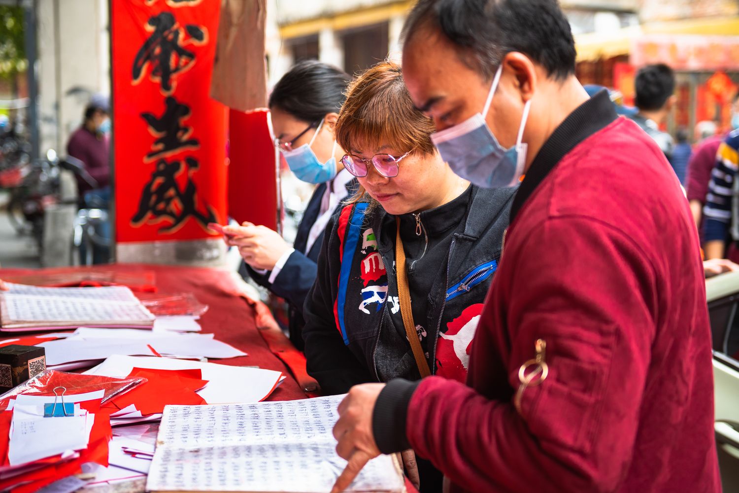 Customers at a calligrapher’s stall in China during the New Year