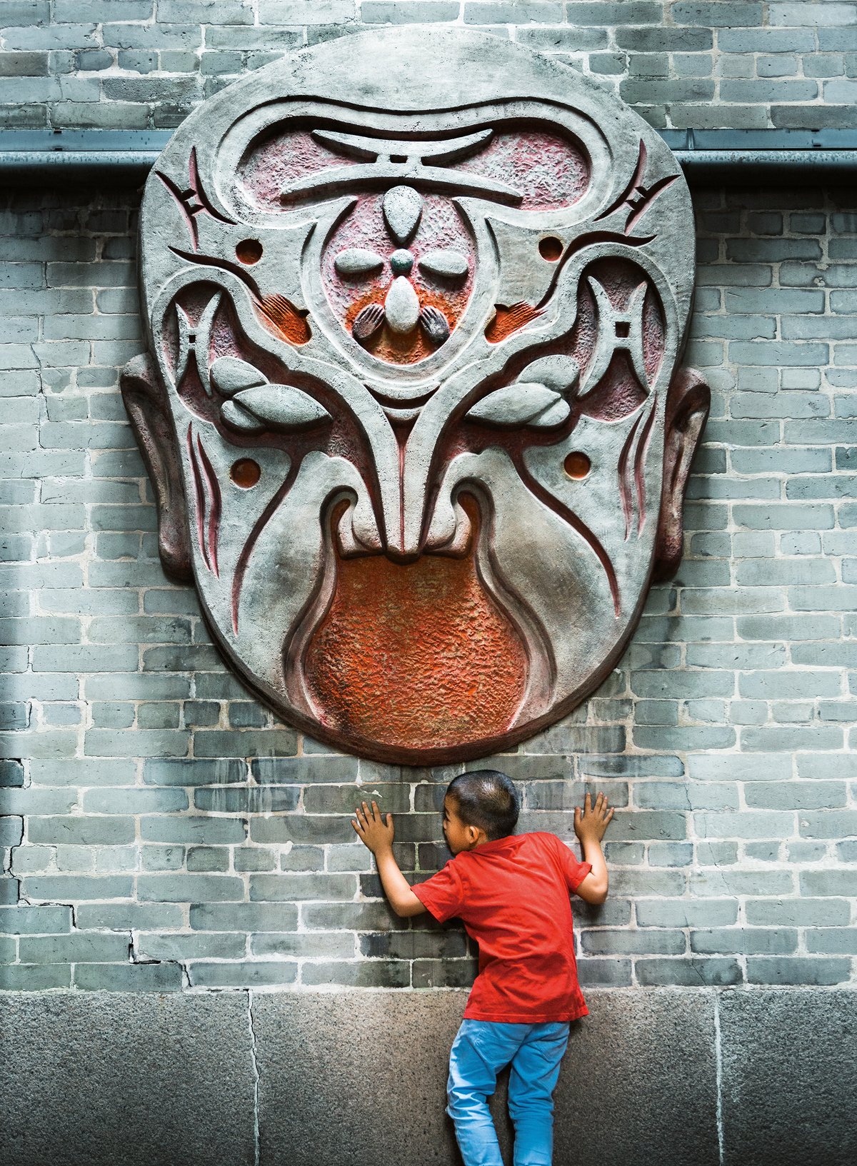 “Dialogue With History” A boy interacts with a mask an opera mask at the Cantonese Opera Mask Museum (Foshan, Guangdong Province, May 2017)