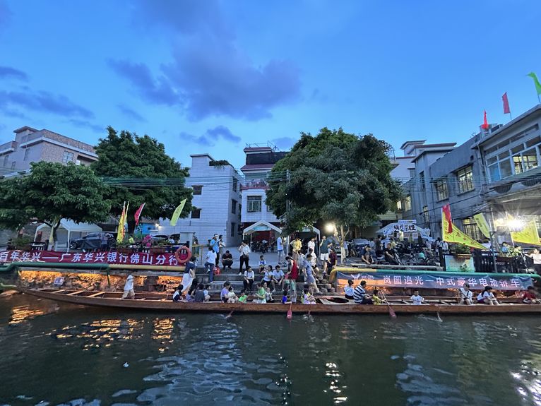 Tourists enjoy a dragon boat tour on the river