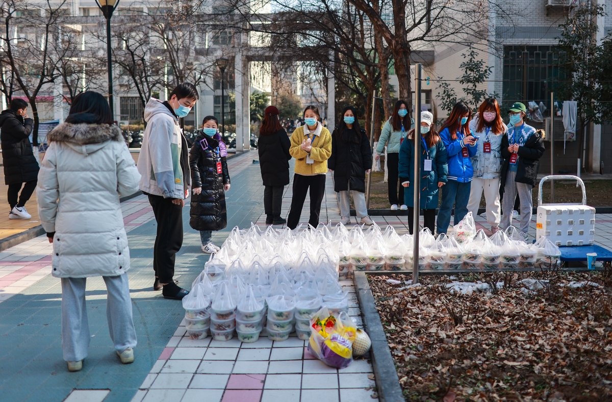 Student and teacher volunteers organize delivery of food to students confined to their dorms