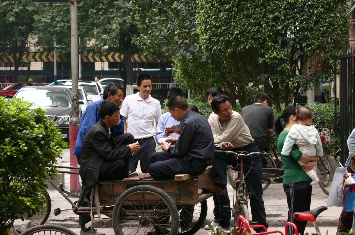 Migrant workers typically gather around the entrance of Xiancun village, waiting for employers seeking laborers to come and find them