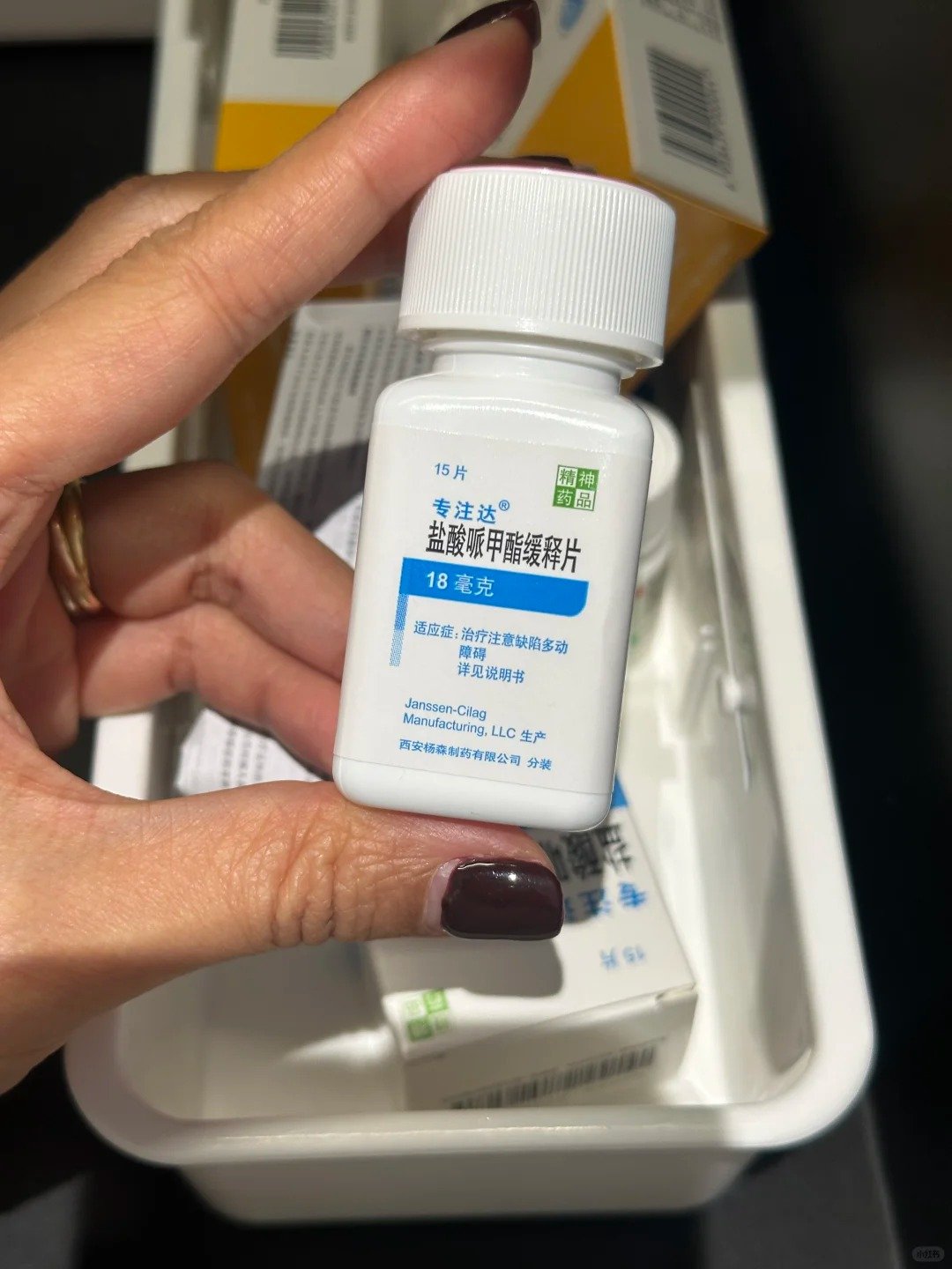 A Chinese woman holds up a bottle of Concerta an ADHD drug