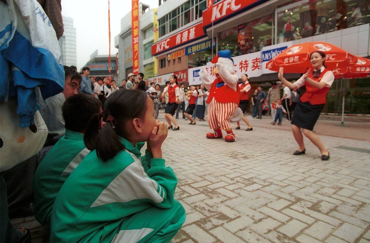 Students on the streets of Nanjing watching a KFC promotional performance in 2000