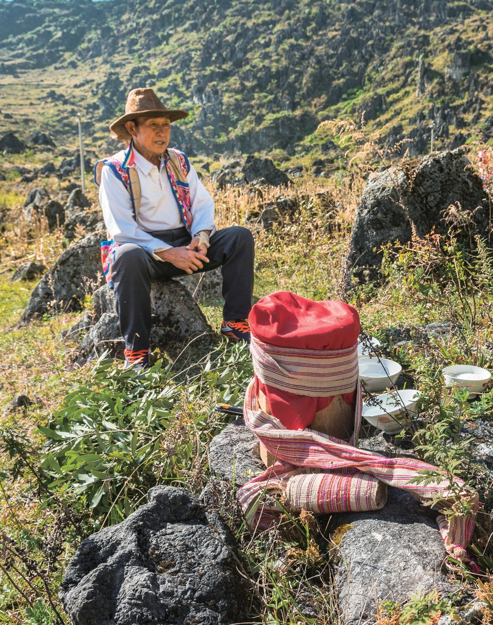 A Bo shaman leads an annual ceremony with the clan and family listening