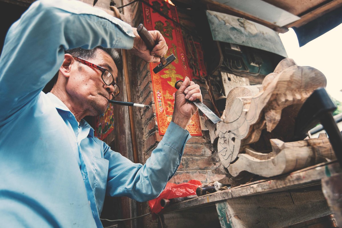 Carving is the first step in making the distinctive dragon figurehead