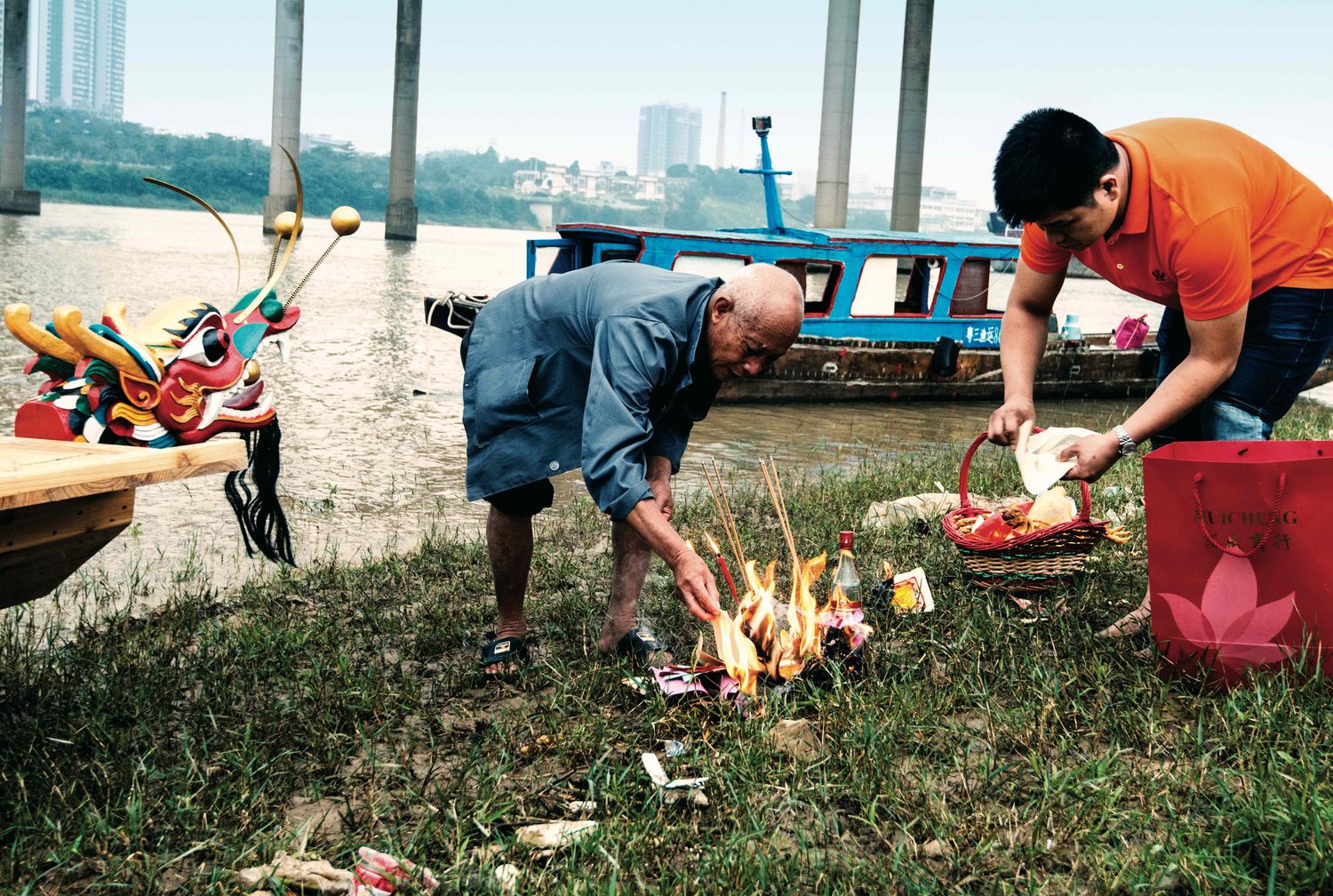 An elder from the village hosts the worship ceremony, lighting incense and offering sacrifices to pray for safety and peace