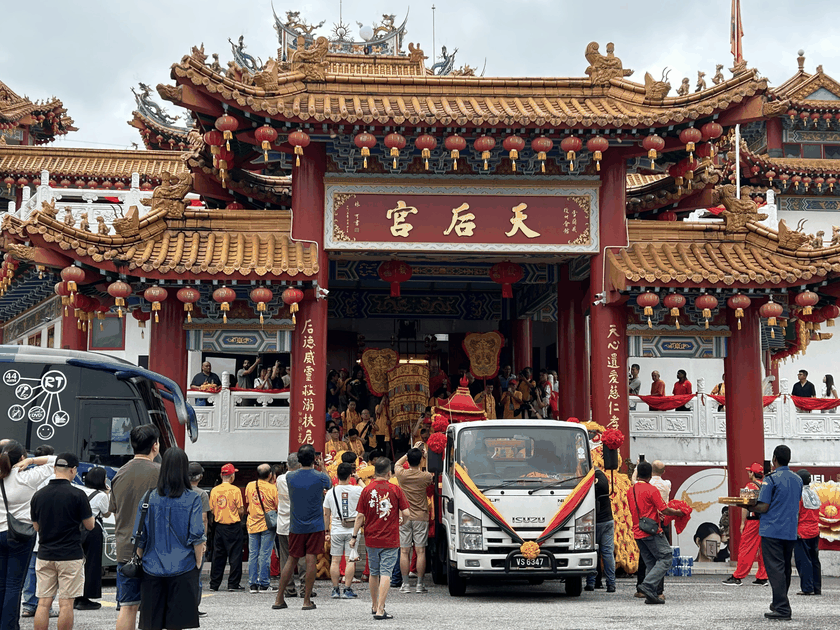 Tourists walking into a Heavenly Empress Temple in Malaysia