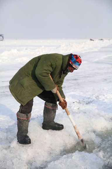 A fisherman practices a thousand-year ice-fishing tradition on Chagan Lake, Jilin