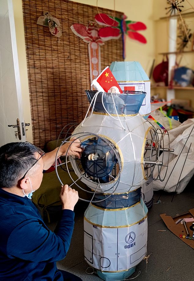 Liu Zhijiang puts together the space station kite in his studio