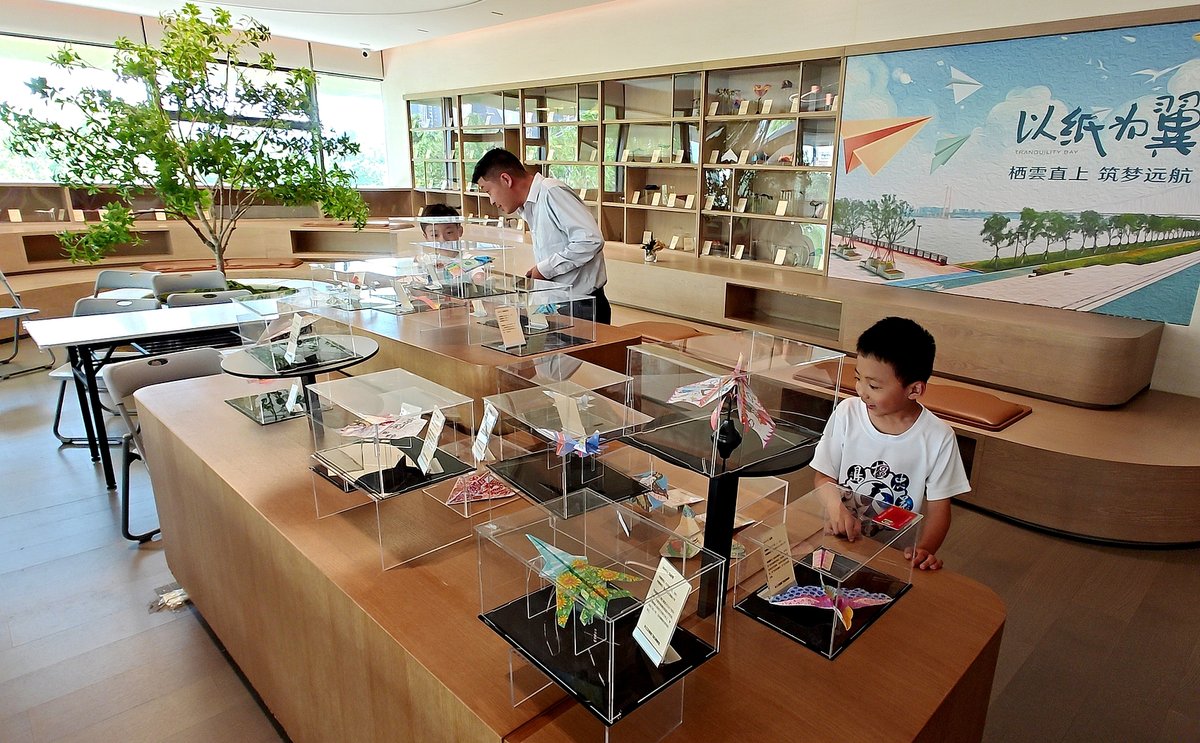 Visitors at the paper plane museum, paper plane workshop