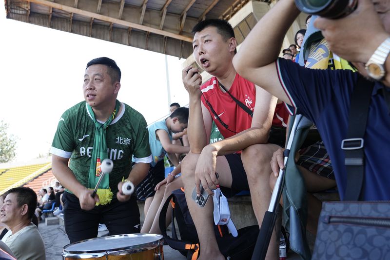 male soccer fans support Beijing Women's Football Club