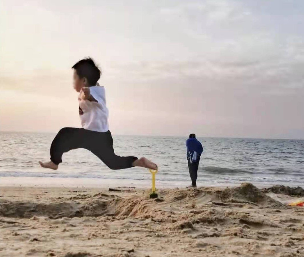 Lele jumping around at a beach