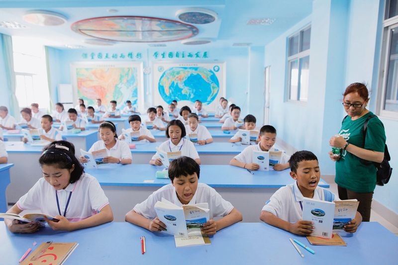 Middle school students study from a Tibetan textbook in an “ethnic class” in Shunde, Guangdong province