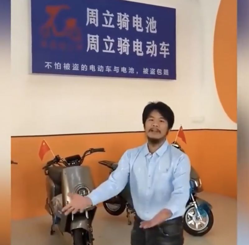 Zhou Liqi working at a scooter company in Guangxi
