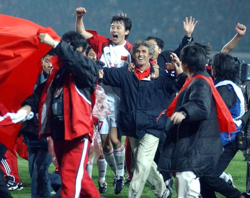 Coach Bora Milutinovic and players celebrated wildly on the pitch at the Wulihe Stadium in Shenyang when they secured qualification