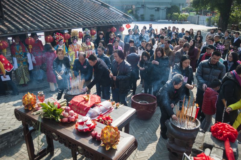 Locals engage in a traditional ceremony honoring the kitchen god as part of their celebration of Little New Year in Foshan, Guangdong
