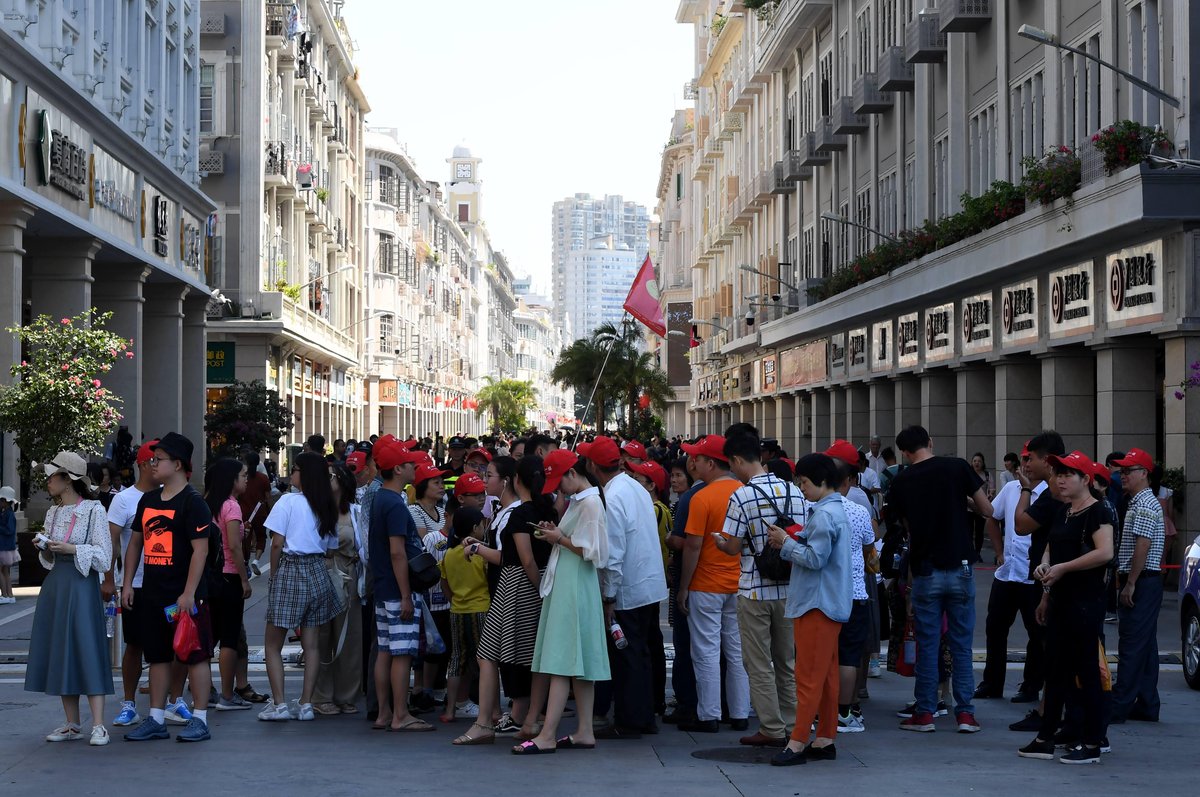 Chinese tourists following a tour guide in Xiamen, Fujian province