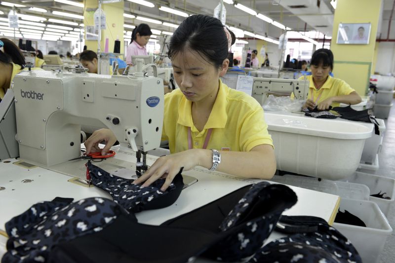 Young workers stitching underwear in a factory in Dongguan, Guangdong province, one of China's biggest manufacturing cities