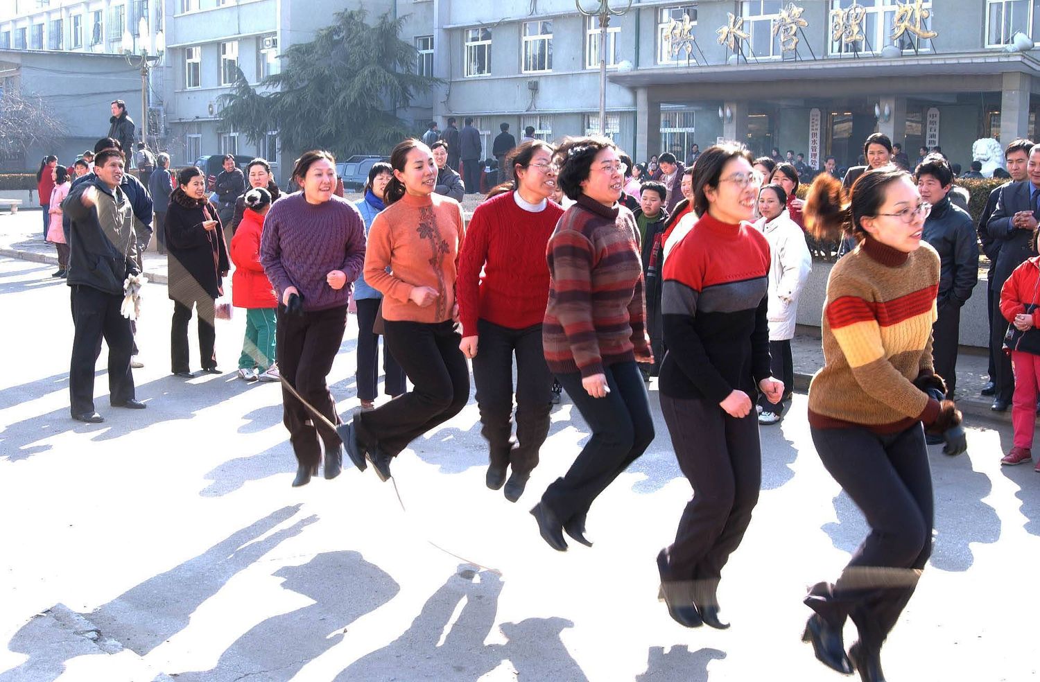 Companies often arrange creative ways to celebrate the day. For female employees of this water bureau office in Henan province in 2002, this involved skipping in a playground, aided by male employees