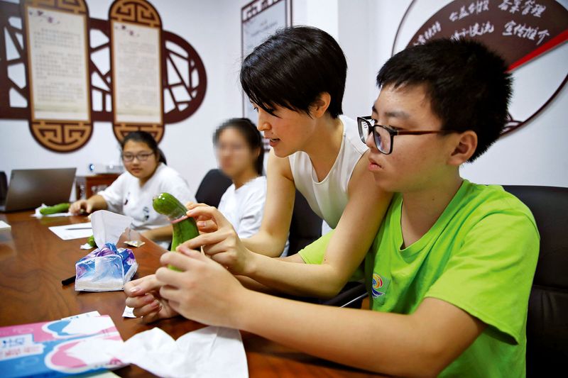 In 2020, a sex educator teaches teenagers how to use a condom in Cixi, Zhejiang province