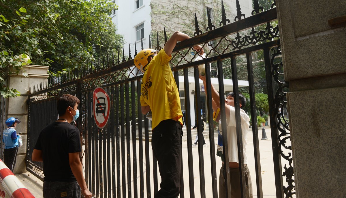 Delivery driver delivering food to student stuck on campus