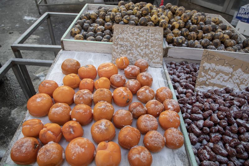 Frozen persimmons for sale in a market in Jilin