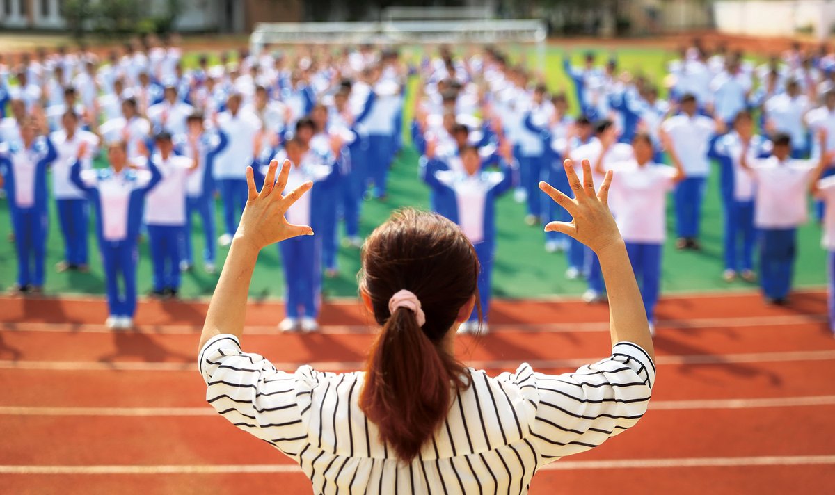 A teacher leads students to sing in sign language at a special education school, Chinese Sign Language Users Struggle to Communicate