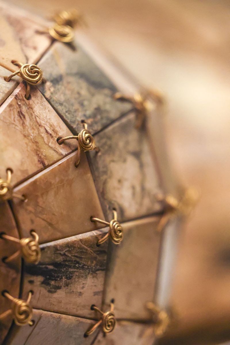 Gold-threading sewn into a jade plates of a suit belonging to Emperor Liu Sheng