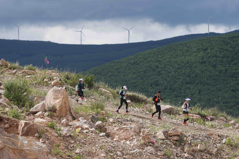 Trail runners trekking across the mountains in Zhangjiakou, Hebei province in July 2023