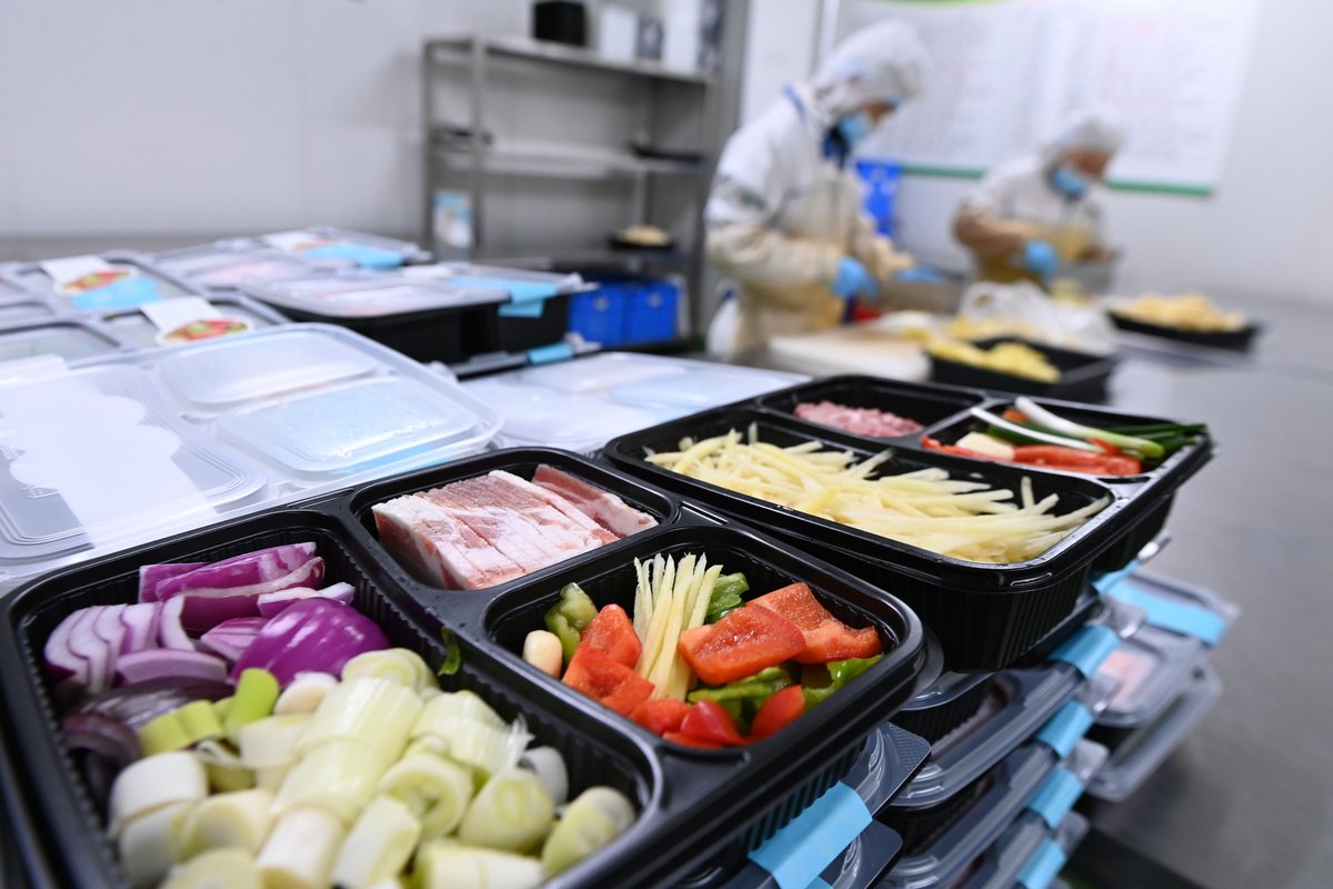 Assembly line workers in Chongqing preparing pre-prepared meals