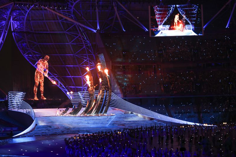 A giant CGI torchbearer seen “lighting” the flame at the 2023 Asian Games in Hangzhou