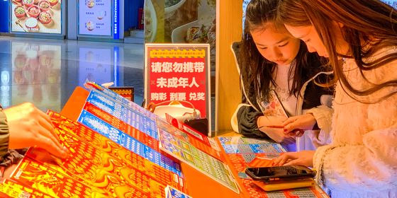 Young people buying scratch lotto tickets in Foshan