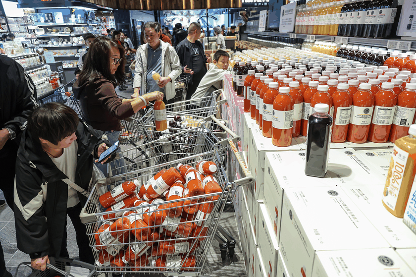 Customers shop at Pangdonglai, a Chinese local supermarket chain in Xuchang, Henan