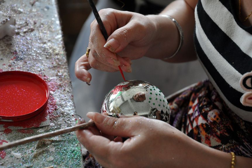 Factory worker making Christmas ornaments in China