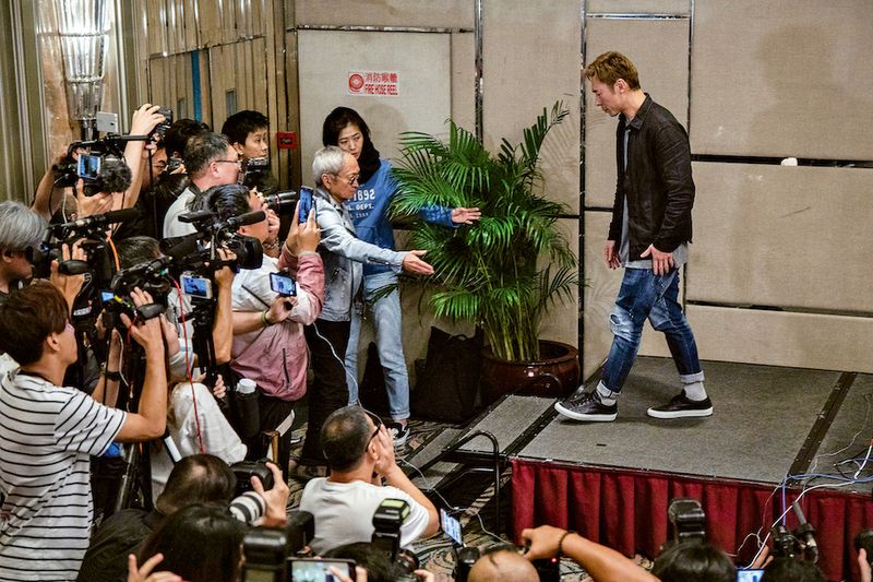 Hong Kong pop star Andy Hui leaving after a press conference