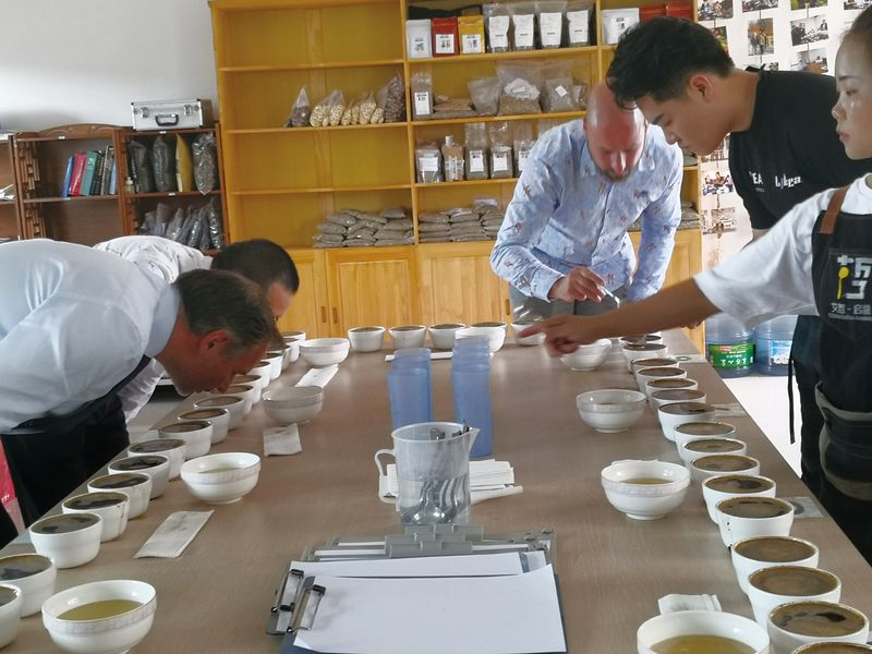 Guests at Li’s plantation sample coffee after roasting to determine its quality, grade, and taste notes
