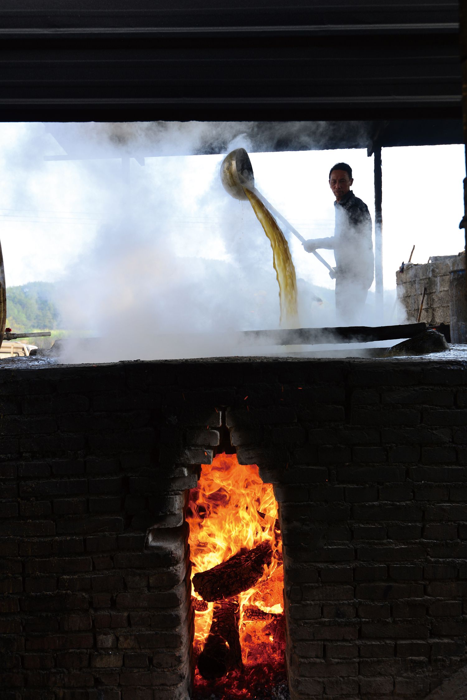 Workers will transfer the cane juice into another pot to cool if the pot overheats