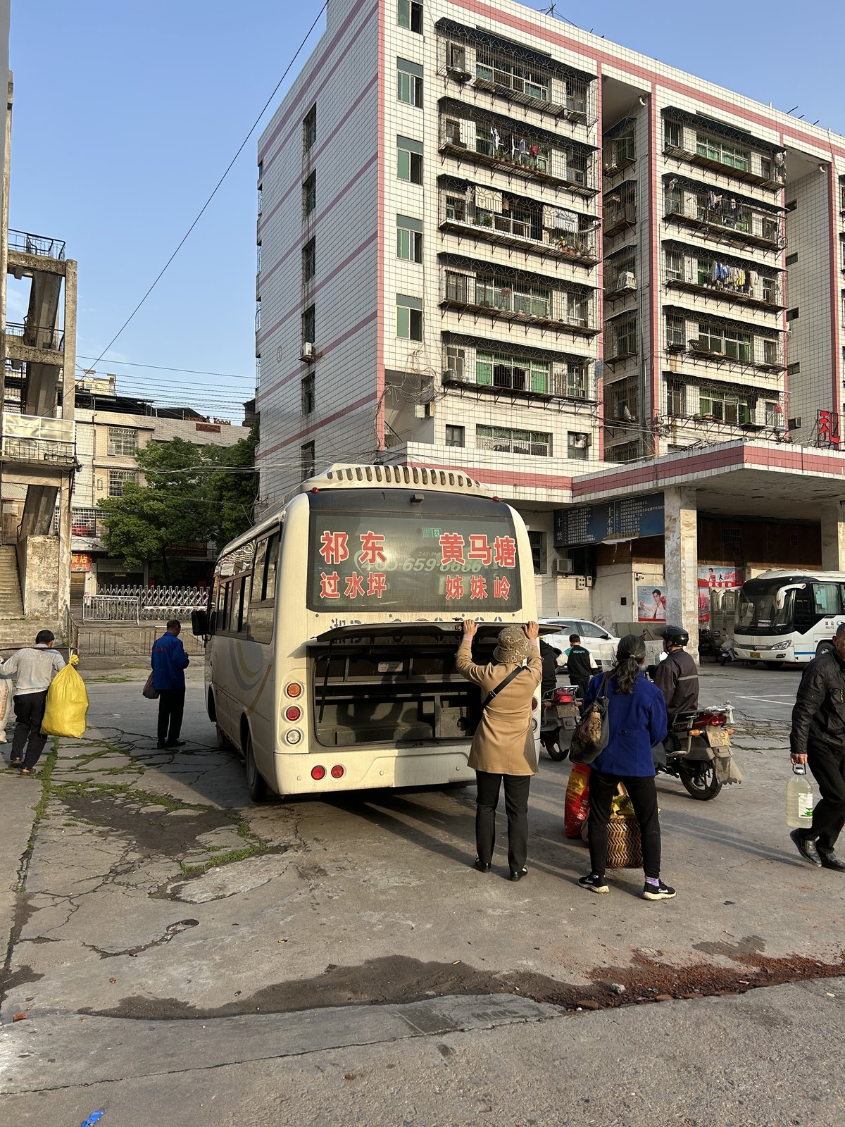 Elderly Chinese villagers taking the bus to town to sell vegetables