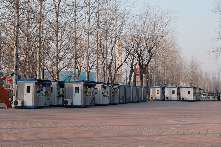 A row of testing booths have been removed from street corners and now sit idle in a Beijing park (Wang Jiawei)